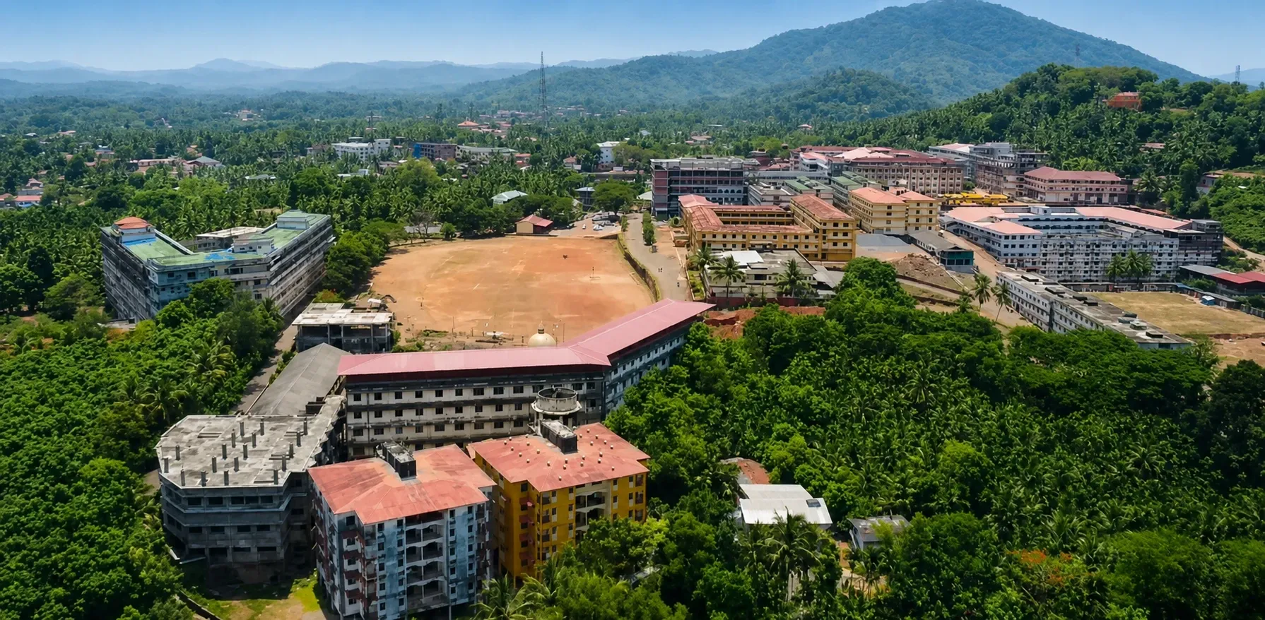 Aerial view of the KVG Dental College campus surrounded by green hills
