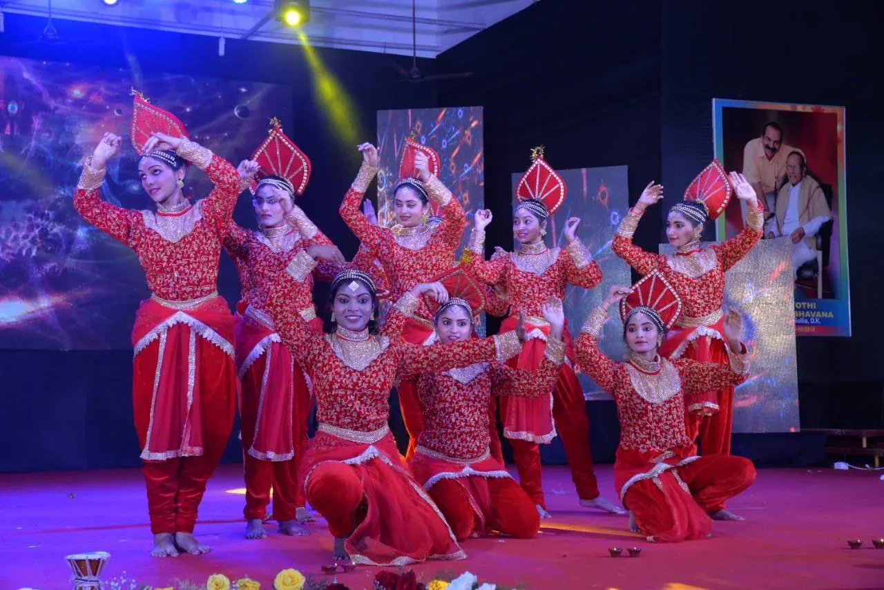 Students presenting a coordinated cultural dance on stage