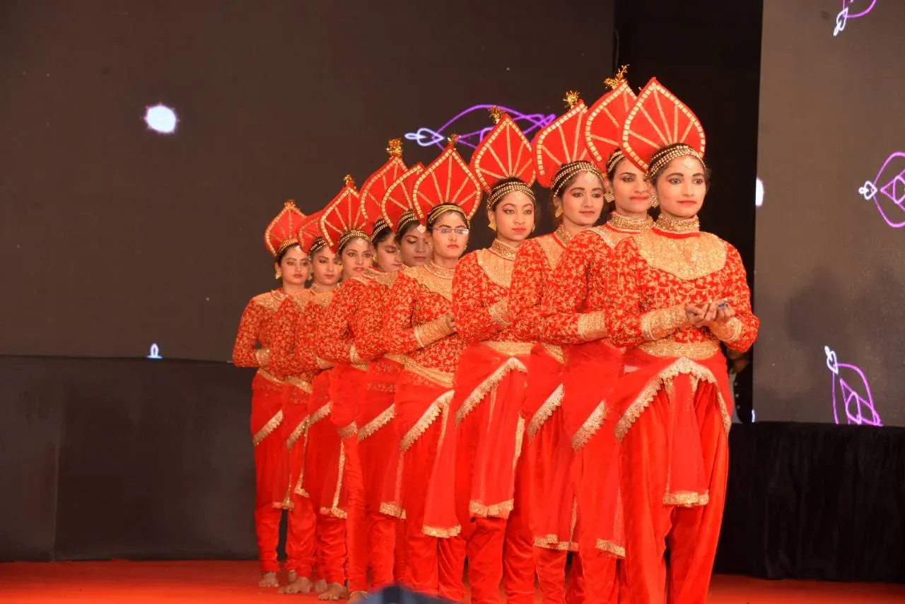 Students in red costumes lined up during a cultural performance
