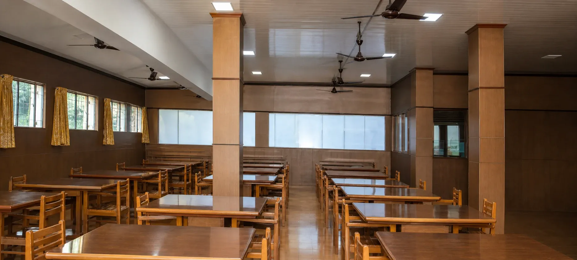 Library reading hall with wooden tables and benches