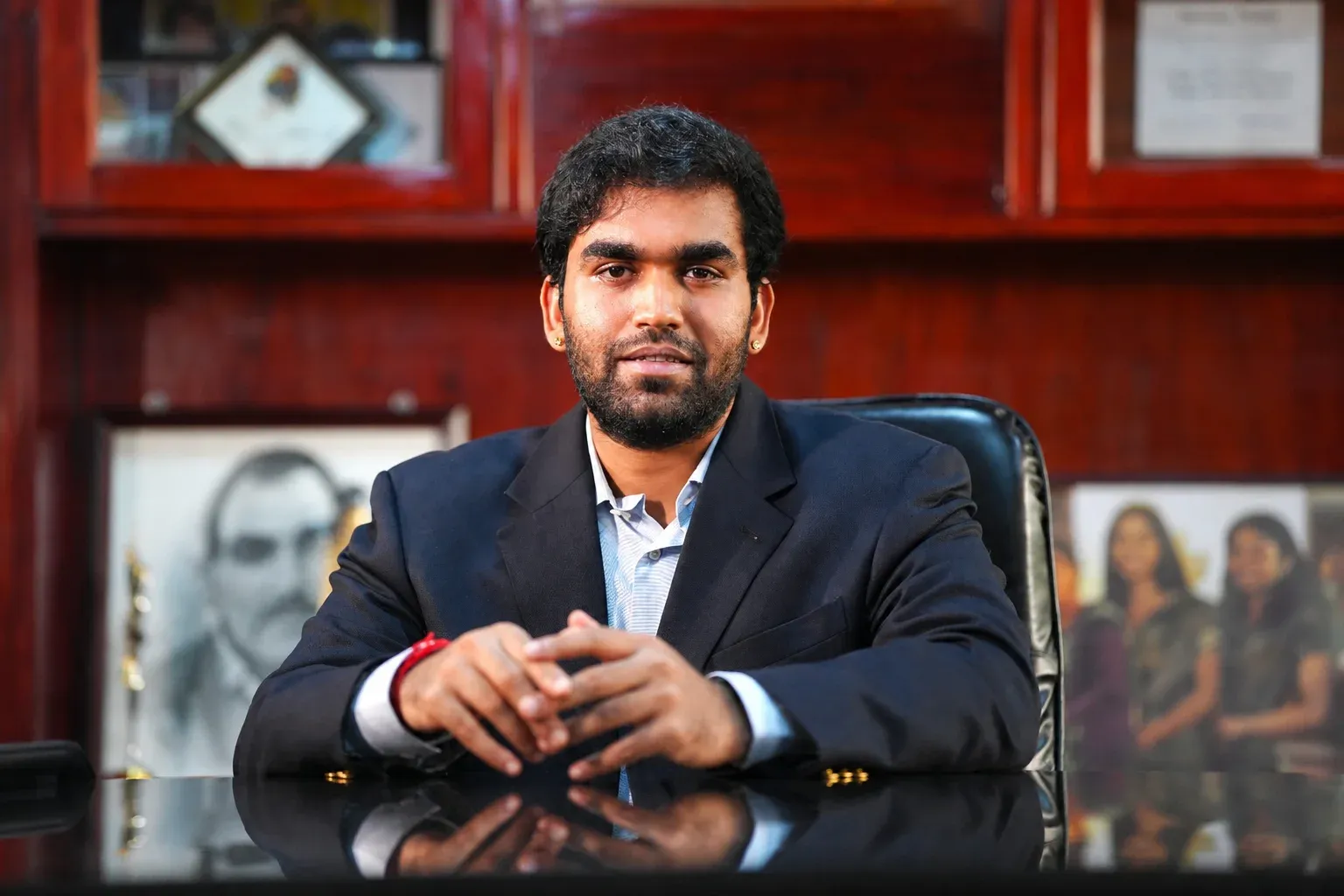 Mr. Maurya R. Kurunji seated in his office