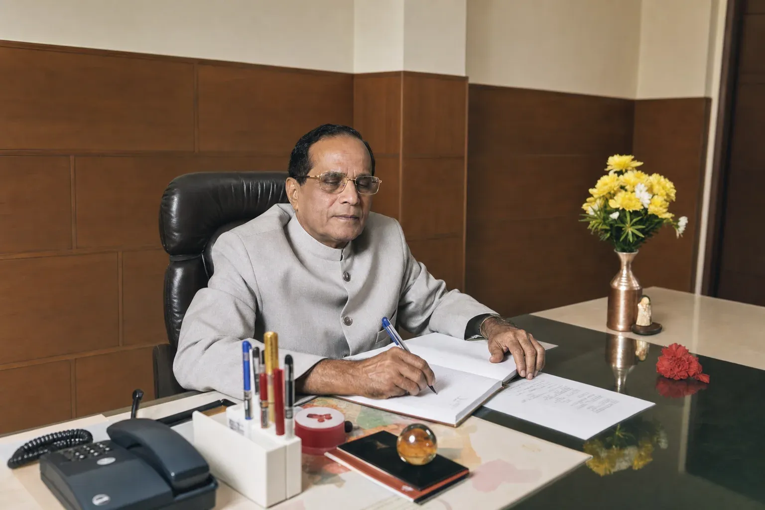 Late Dr. Kurunji Venkatramana Gowda writing at his office desk