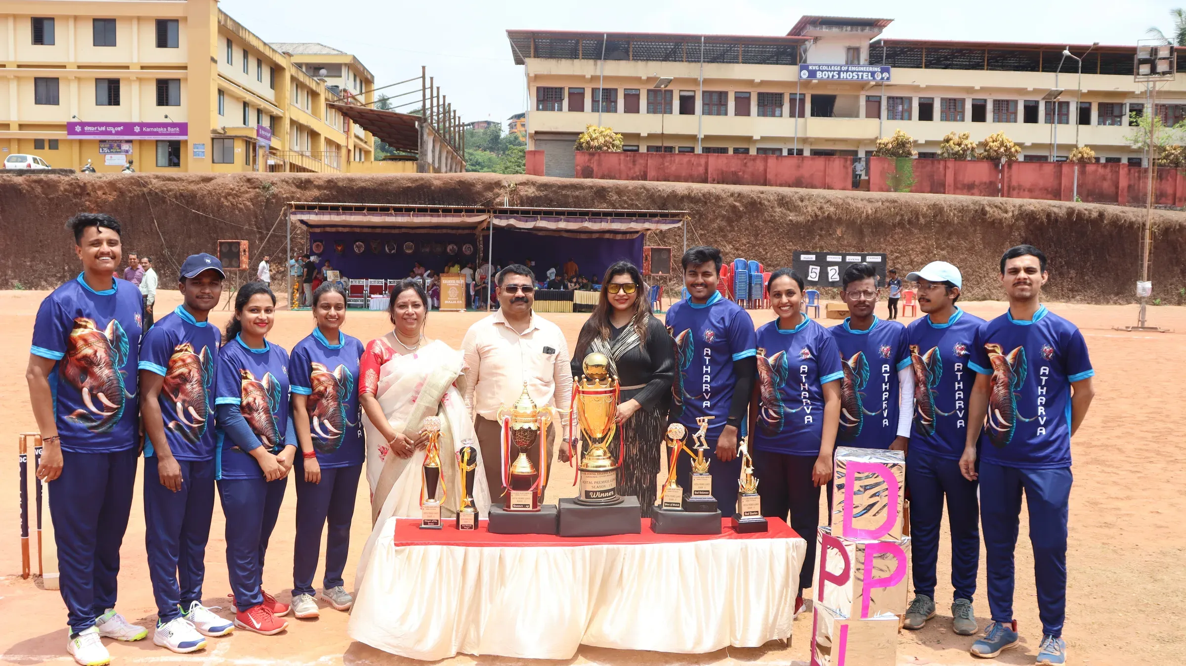 KVG students celebrating a sports victory with their trophies